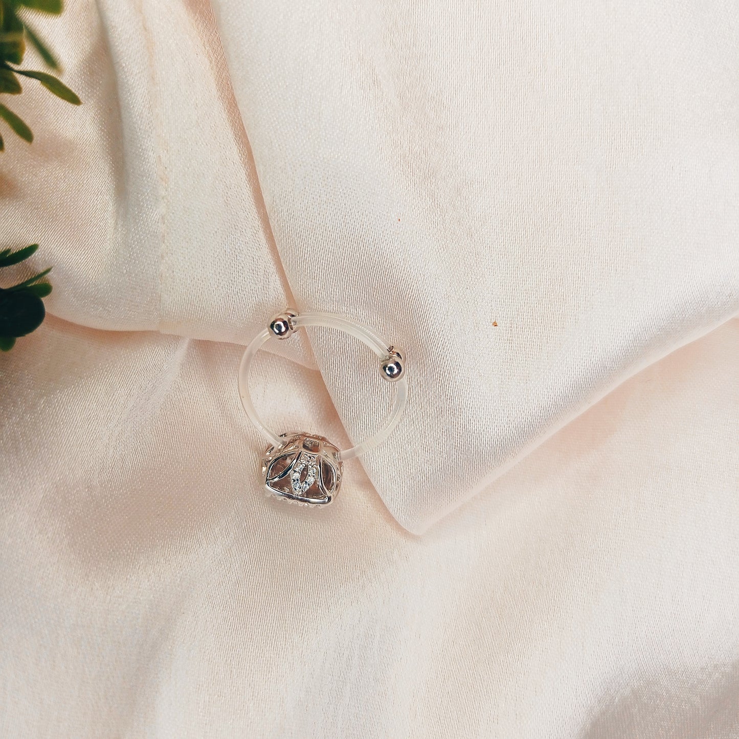 Elegant cushion-cut diamond cluster ring on a woman's hand, featuring a sparkling pave setting and a sleek band—perfect for engagements, weddings, or luxury fashion jewelry lovers