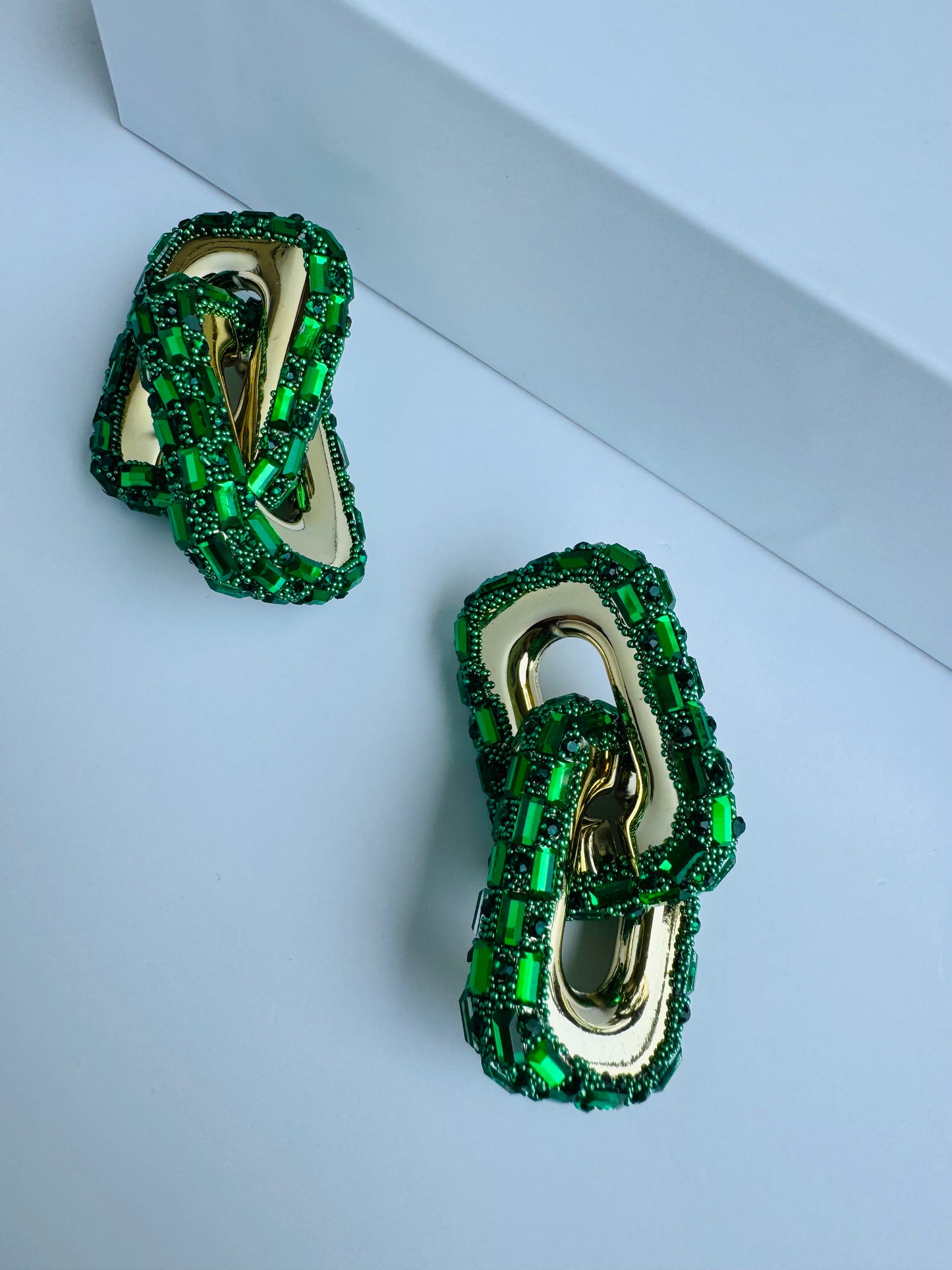 Close-up of bold, green link earrings