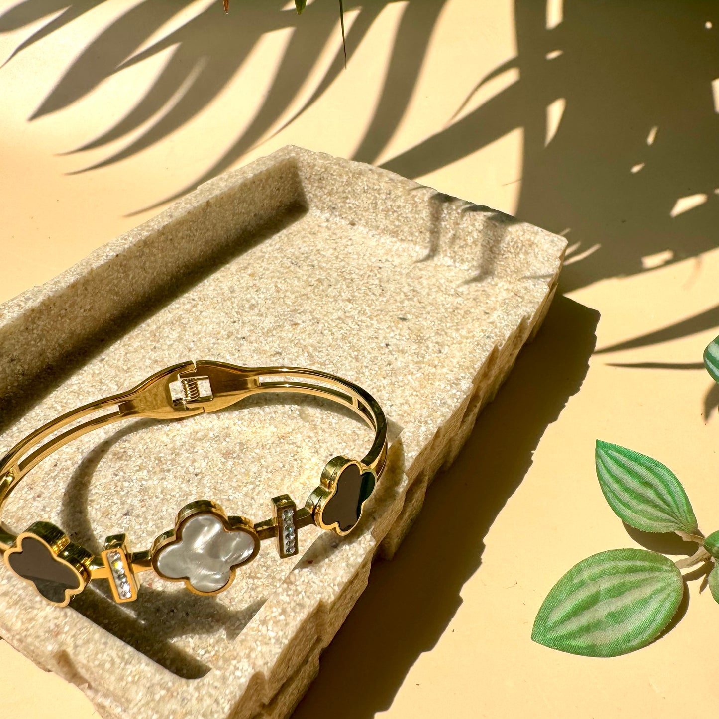 gold bangle with Clover bracelet motifs.