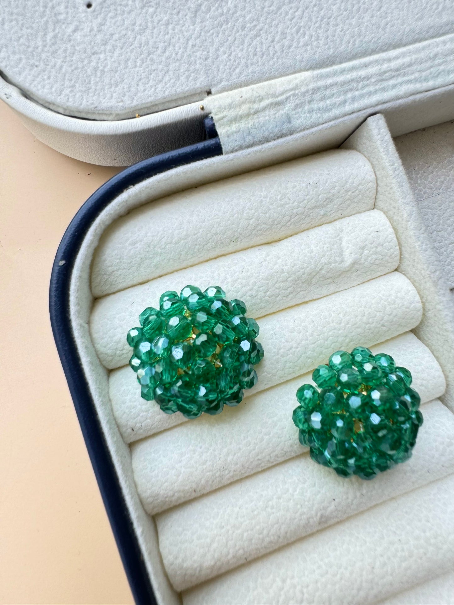 Green iridescent berry bead earrings in a case