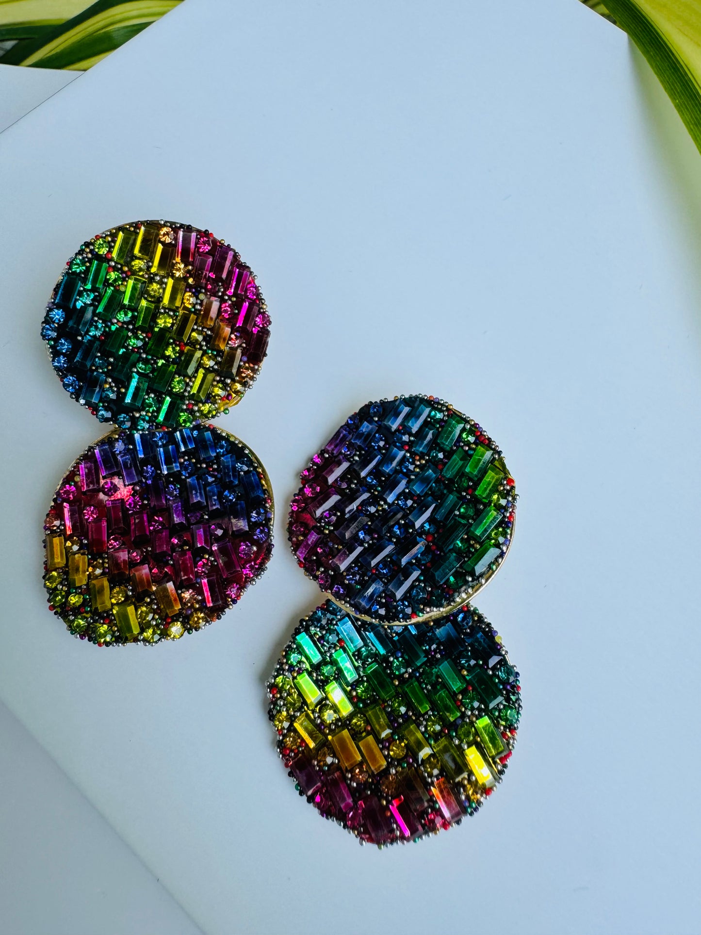 Shimmering earrings featuring a mosaic of rainbow crystals