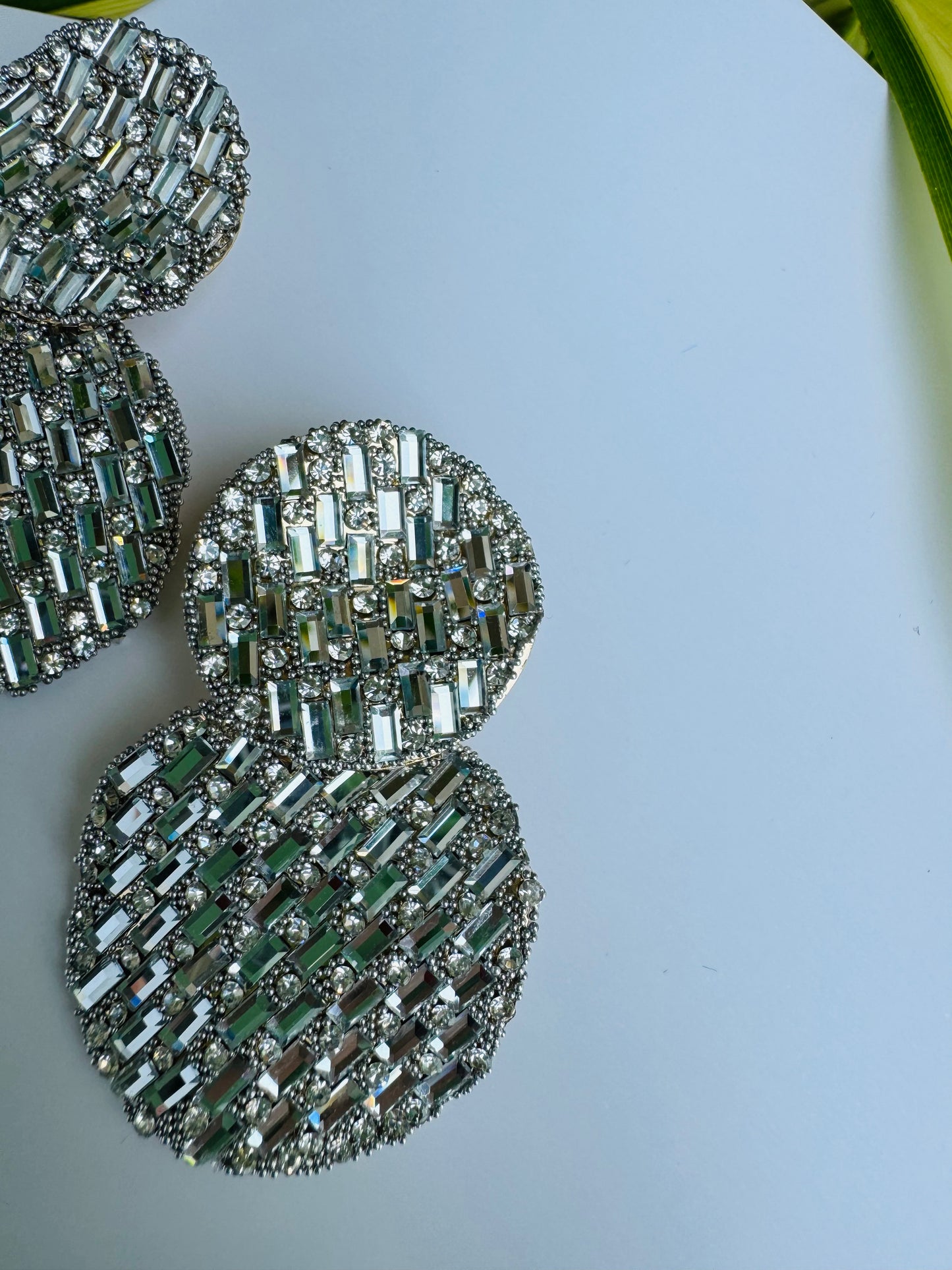 Two pairs of sparkling silver earrings with crystal embellishments