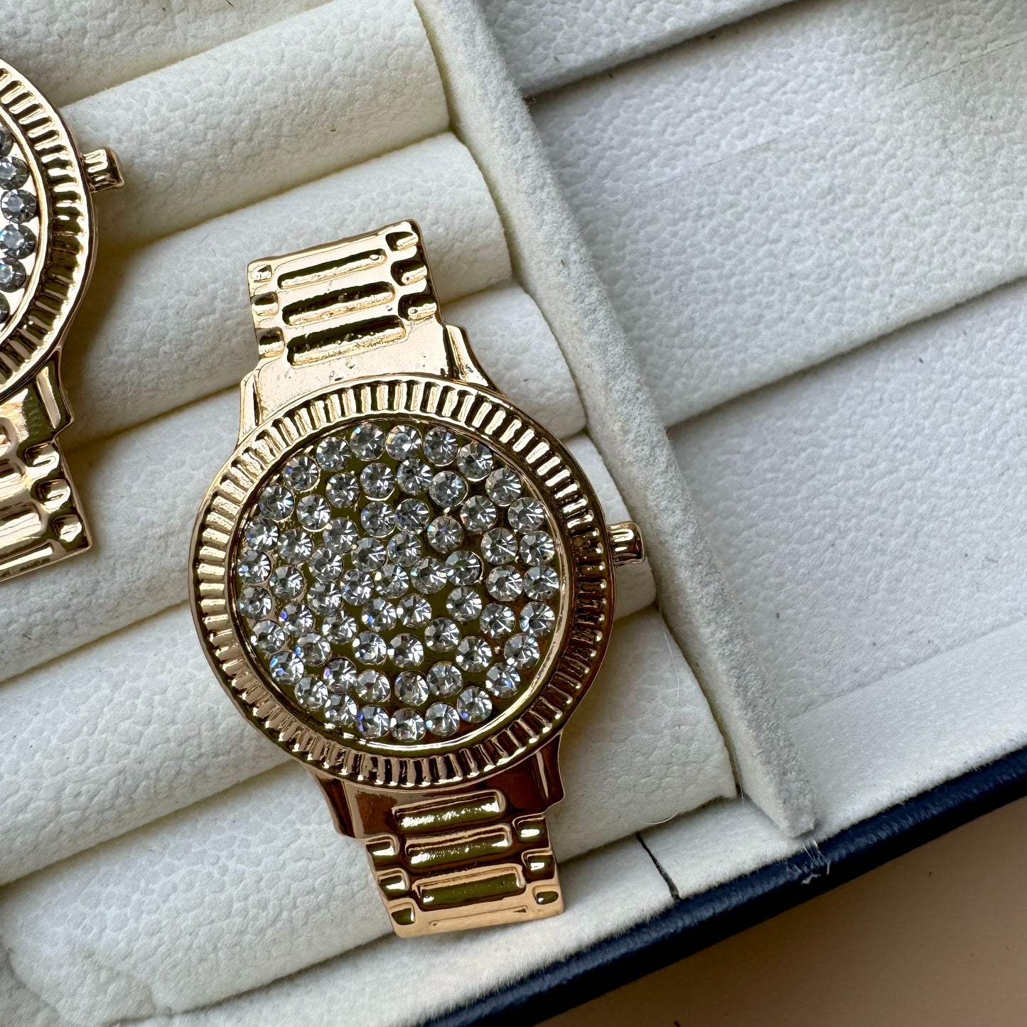 Stylish Lush24 drop earrings with a distinctive studded wristwatch face design, likely available in Mumbai, Maharashtra, India. These gold-toned earrings feature a sparkling, textured surface and a linked drop, presented in a protective jewelry case.