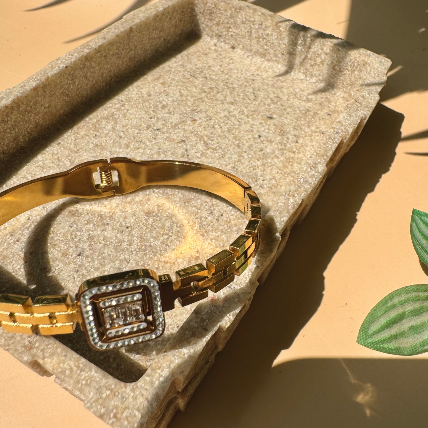 Luxury bracelet on a textured surface.