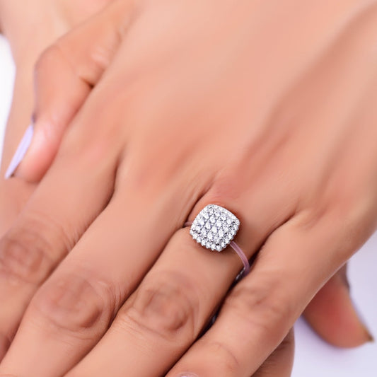 Elegant cushion-cut diamond cluster ring on a woman's hand, featuring a sparkling pave setting and a sleek band—perfect for engagements, weddings, or luxury fashion jewelry lovers