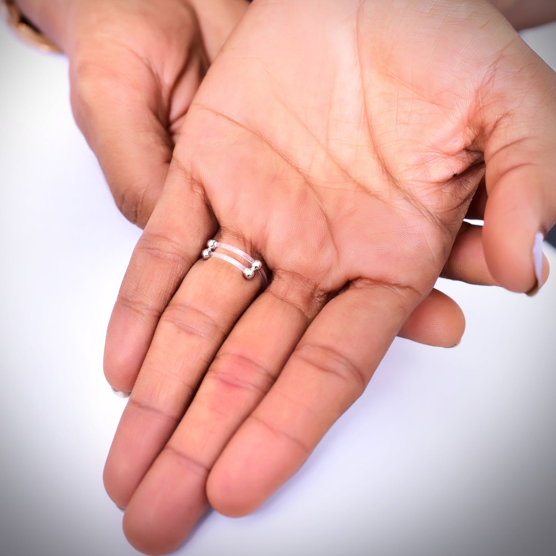 Elegant cushion-cut diamond cluster ring on a woman's hand, featuring a sparkling pave setting and a sleek band—perfect for engagements, weddings, or luxury fashion jewelry lovers