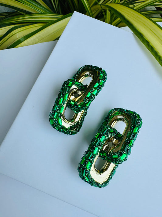Close-up of bold, green link earrings