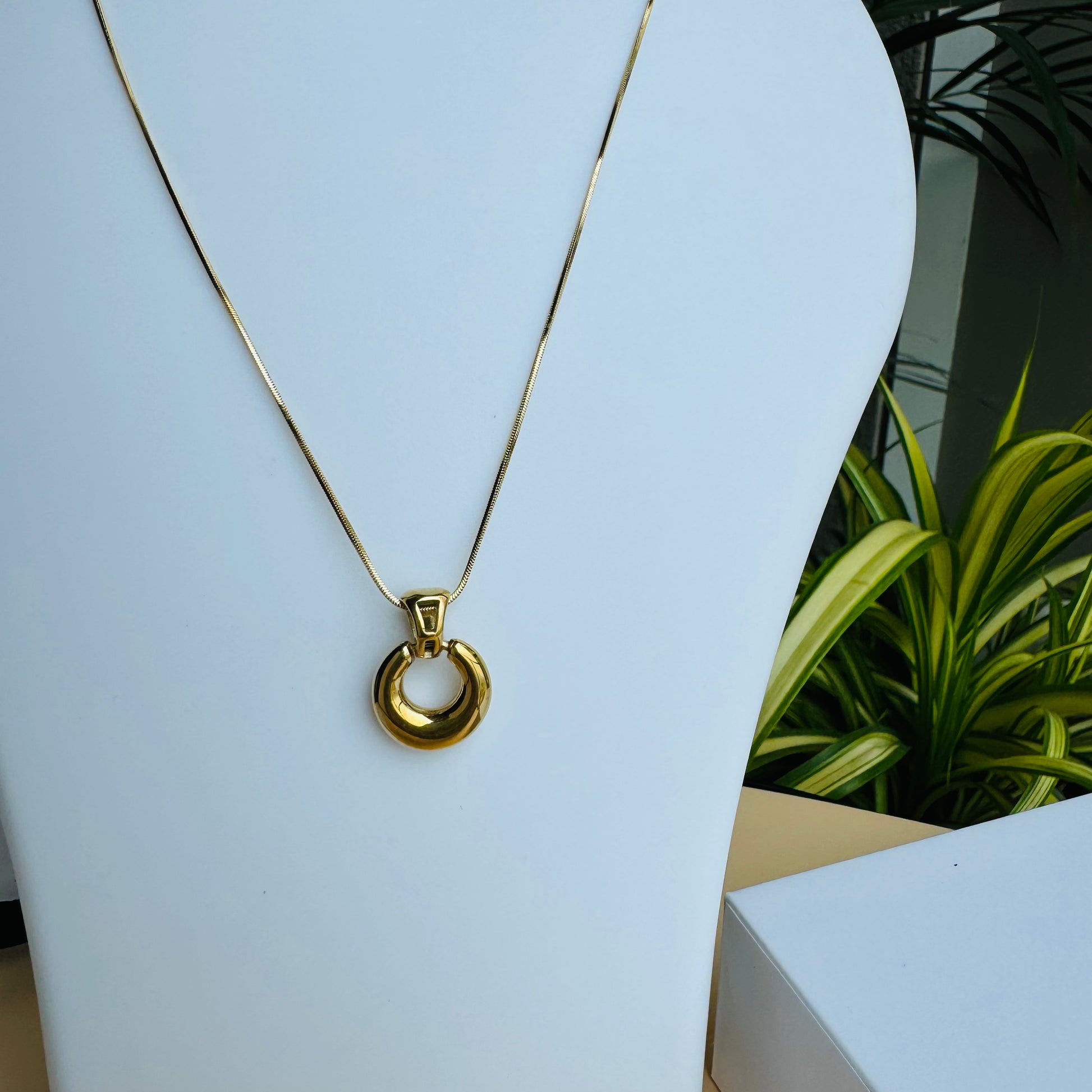 Understated and versatile gold chain necklace on display