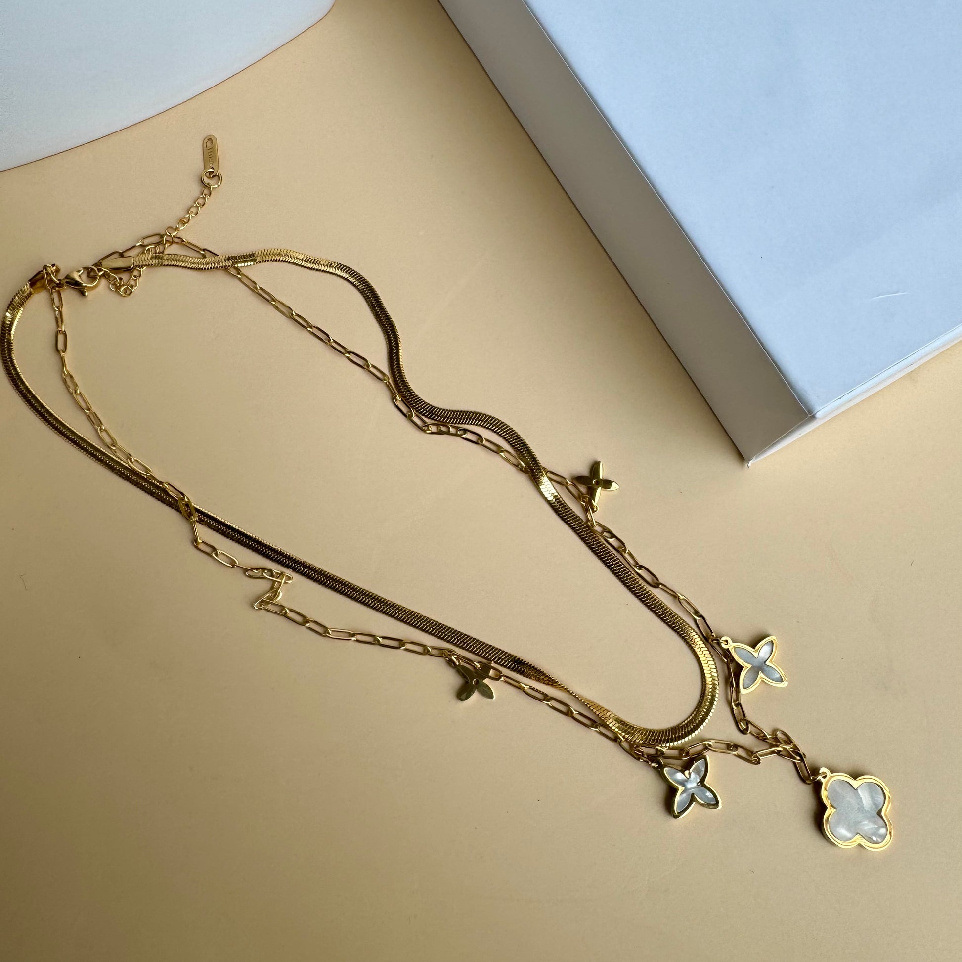 Locally sourced gold chain necklace from "LUSH" displayed on a white bust