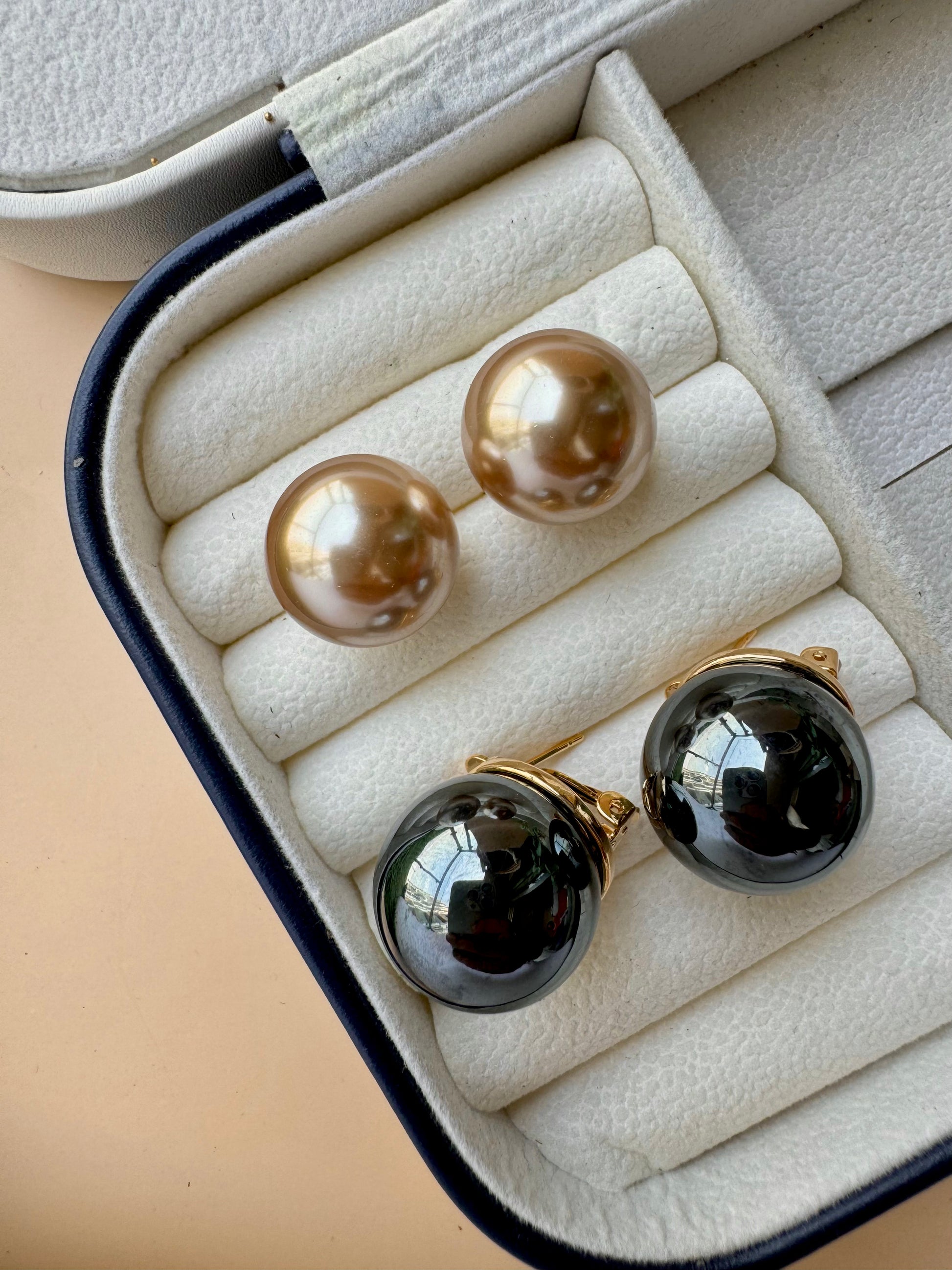 Eye-catching black and gold stud earrings, a unique and colorful jewelry item likely available in Mumbai, Maharashtra, India. 