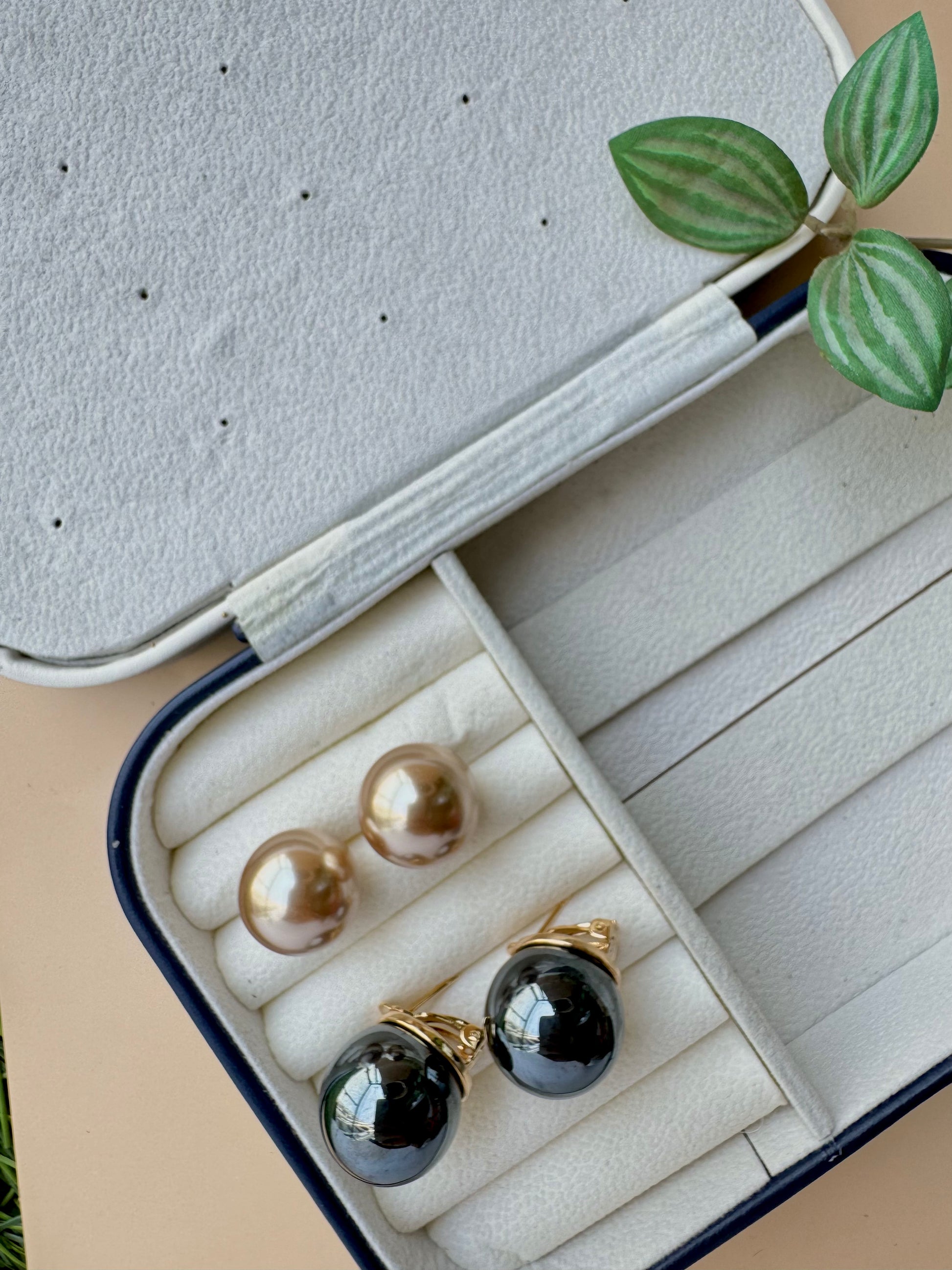 Eye-catching black and gold stud earrings, a unique and colorful jewelry item likely available in Mumbai, Maharashtra, India. 