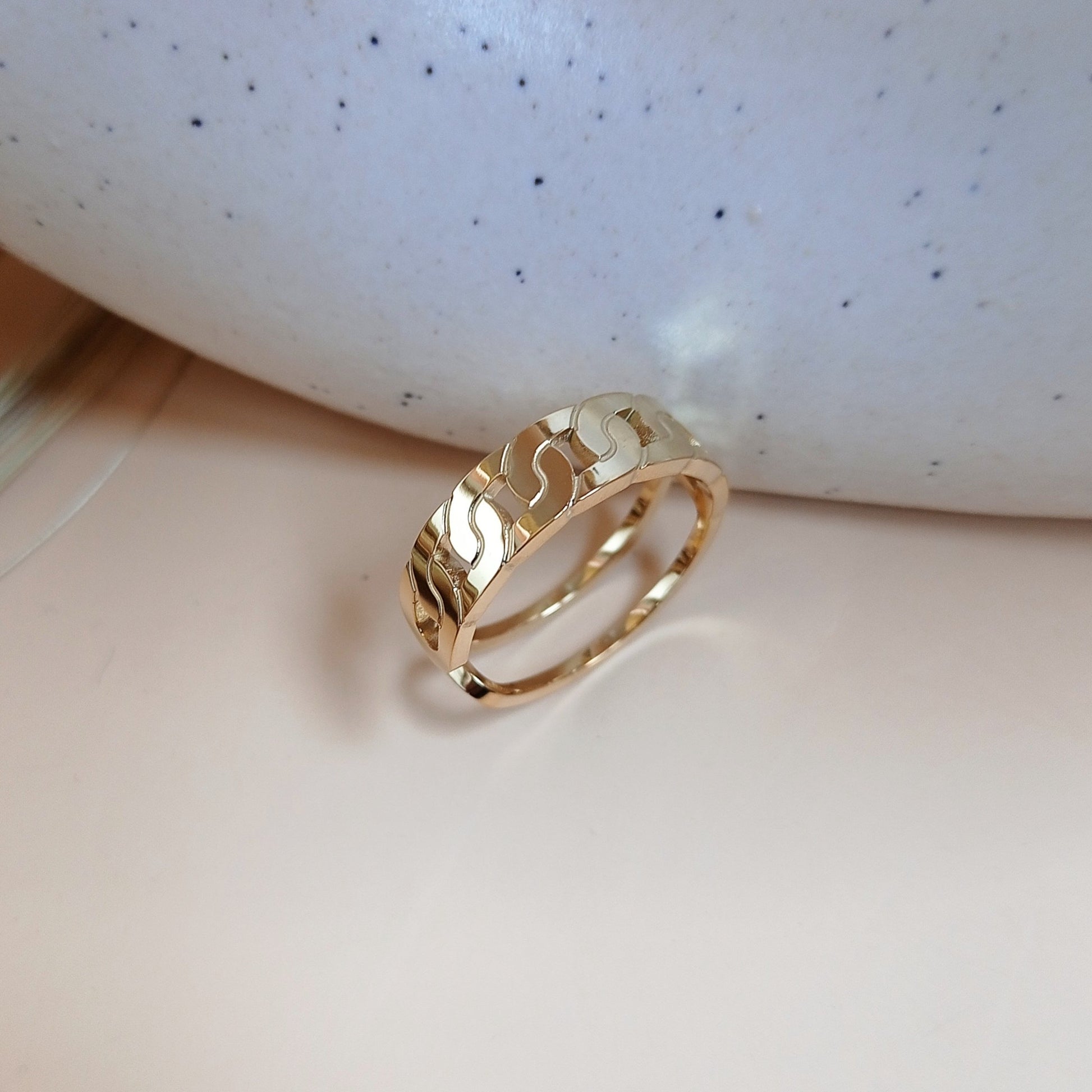 Elegant gold ring with a modern wavy pattern, reflecting luxury and sophistication—perfect for wedding bands, anniversary gifts, or fine jewelry collections