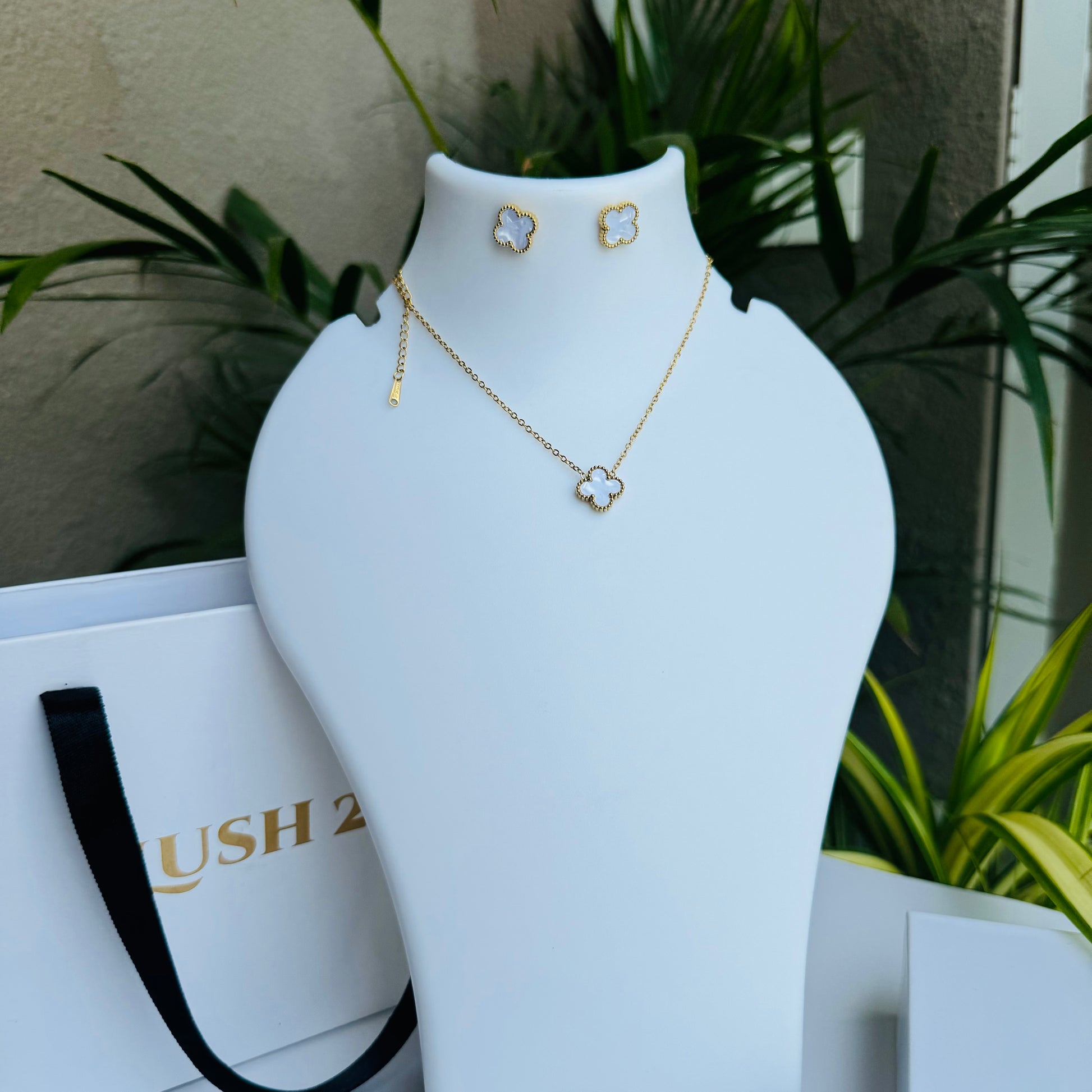 clover pendant necklace showcased with LUSH 24 branding