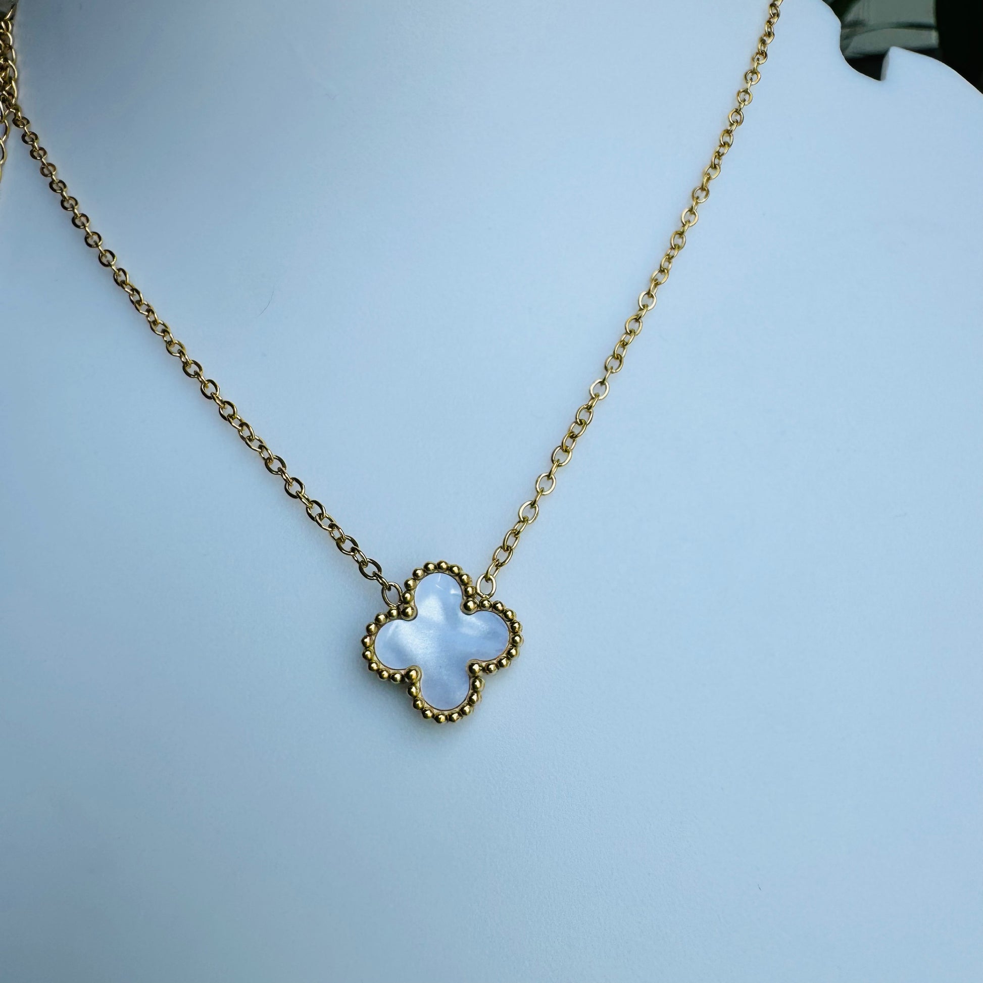 clover pendant necklace showcased with LUSH 24 branding