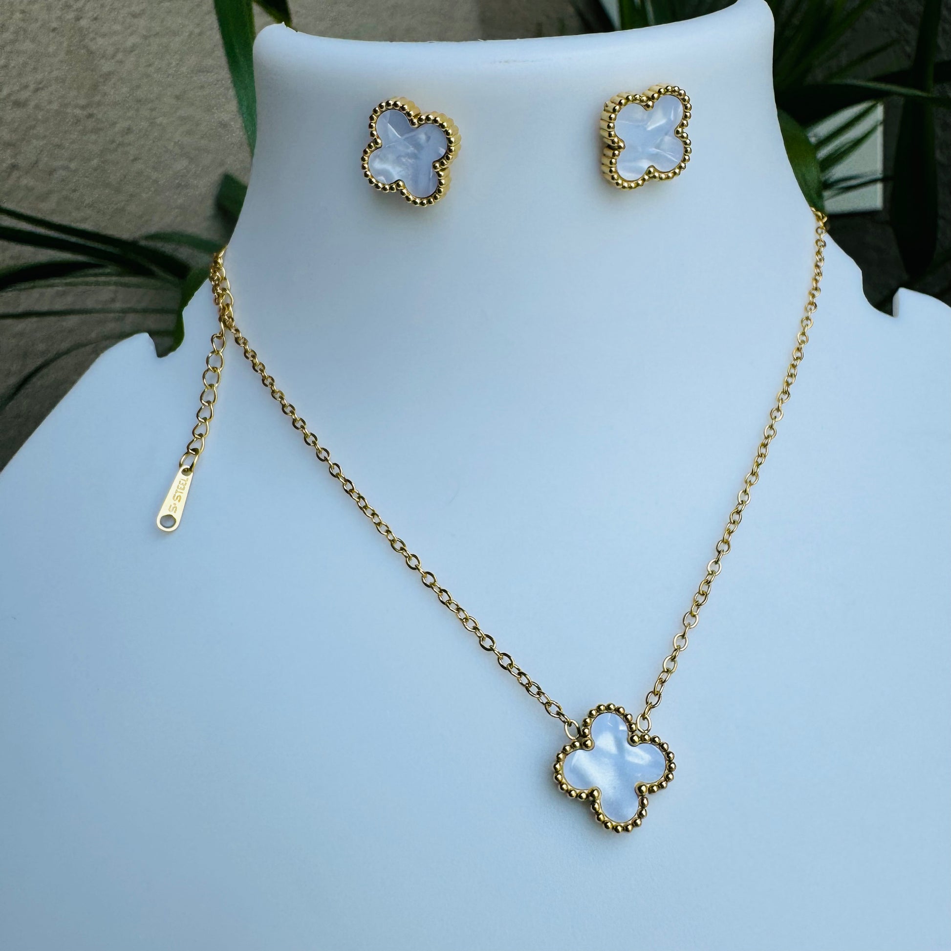 clover pendant necklace showcased with LUSH 24 branding