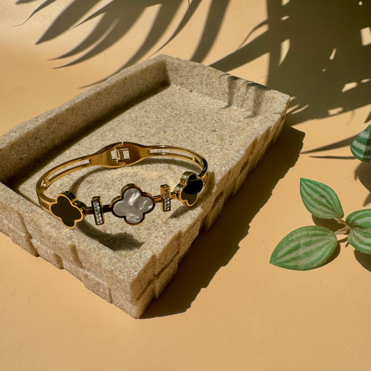 gold bangle with Clover bracelet motifs.