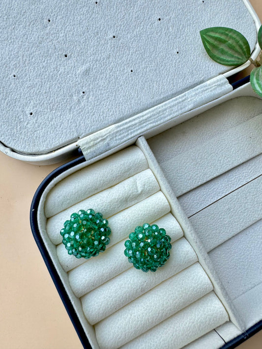 Green iridescent berry bead earrings in a case