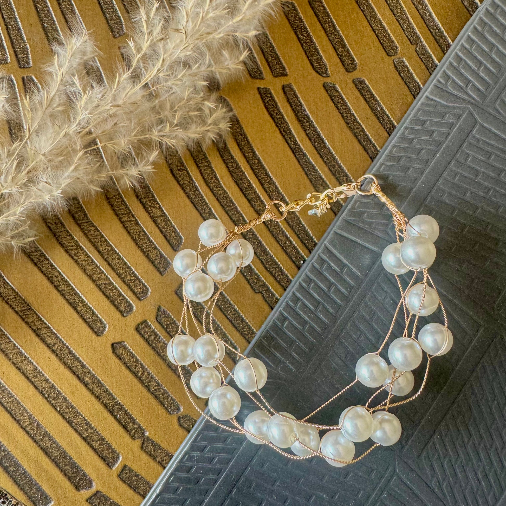 Intertwined pearl gold bracelet