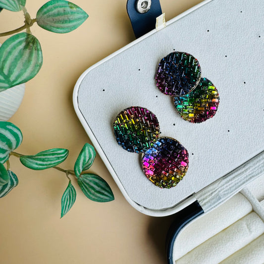 Shimmering earrings featuring a mosaic of rainbow crystals