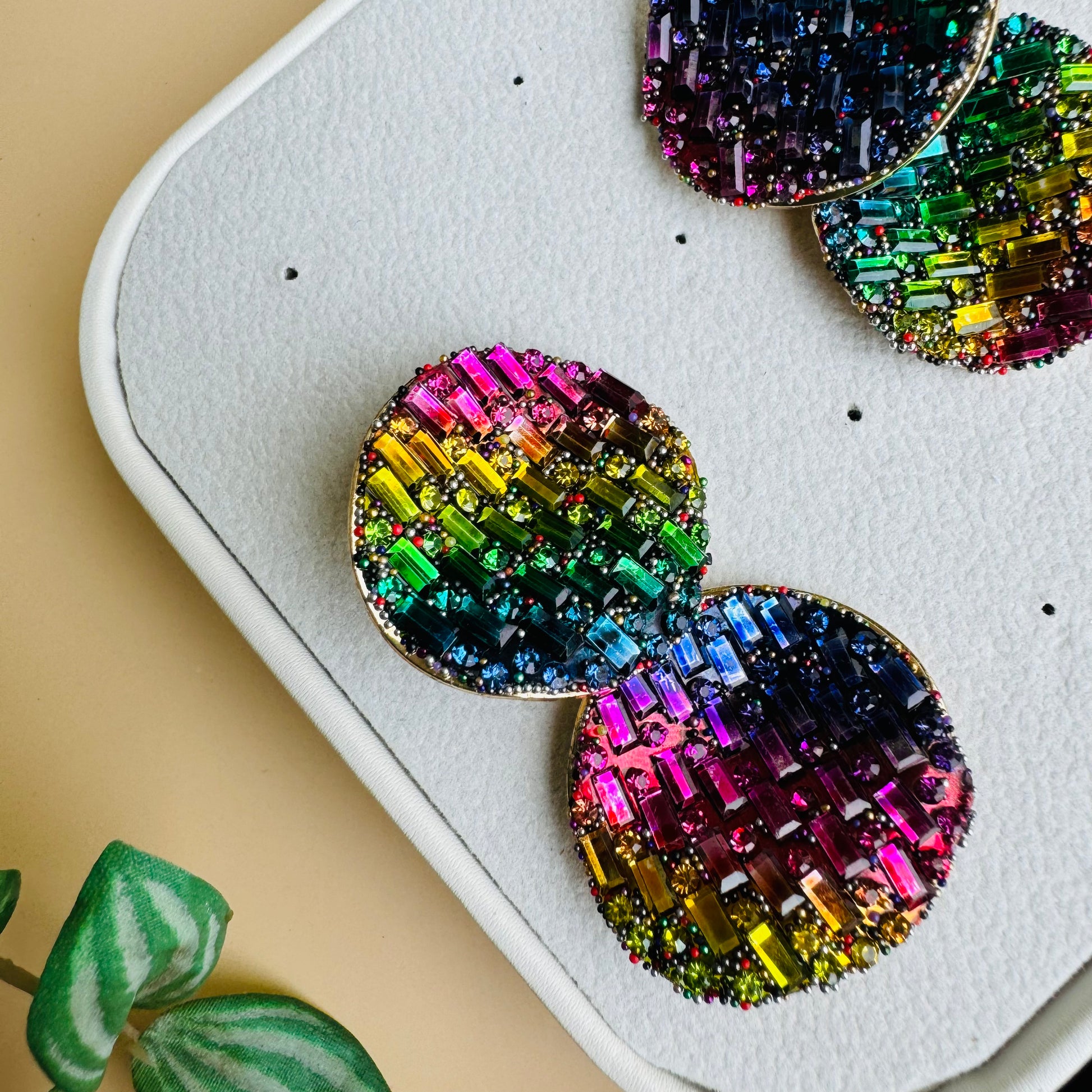 Shimmering earrings featuring a mosaic of rainbow crystals