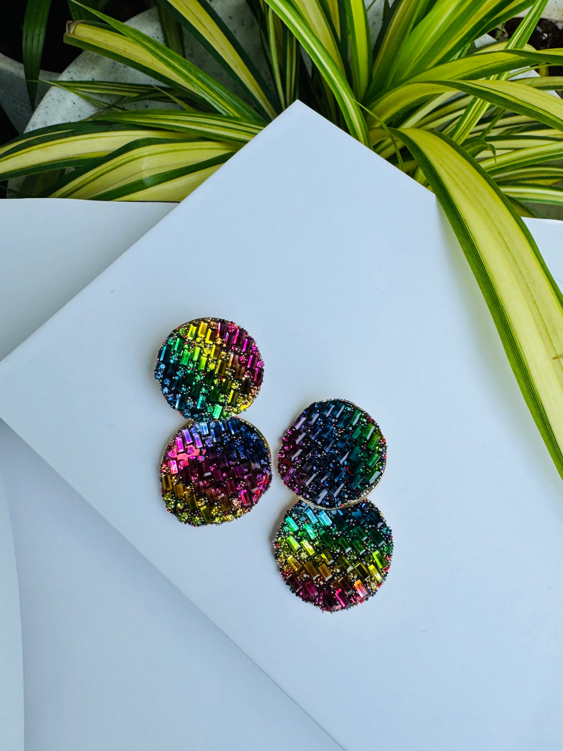 Shimmering earrings featuring a mosaic of rainbow crystals