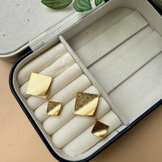 Elegant gold kite earrings in a display box.
