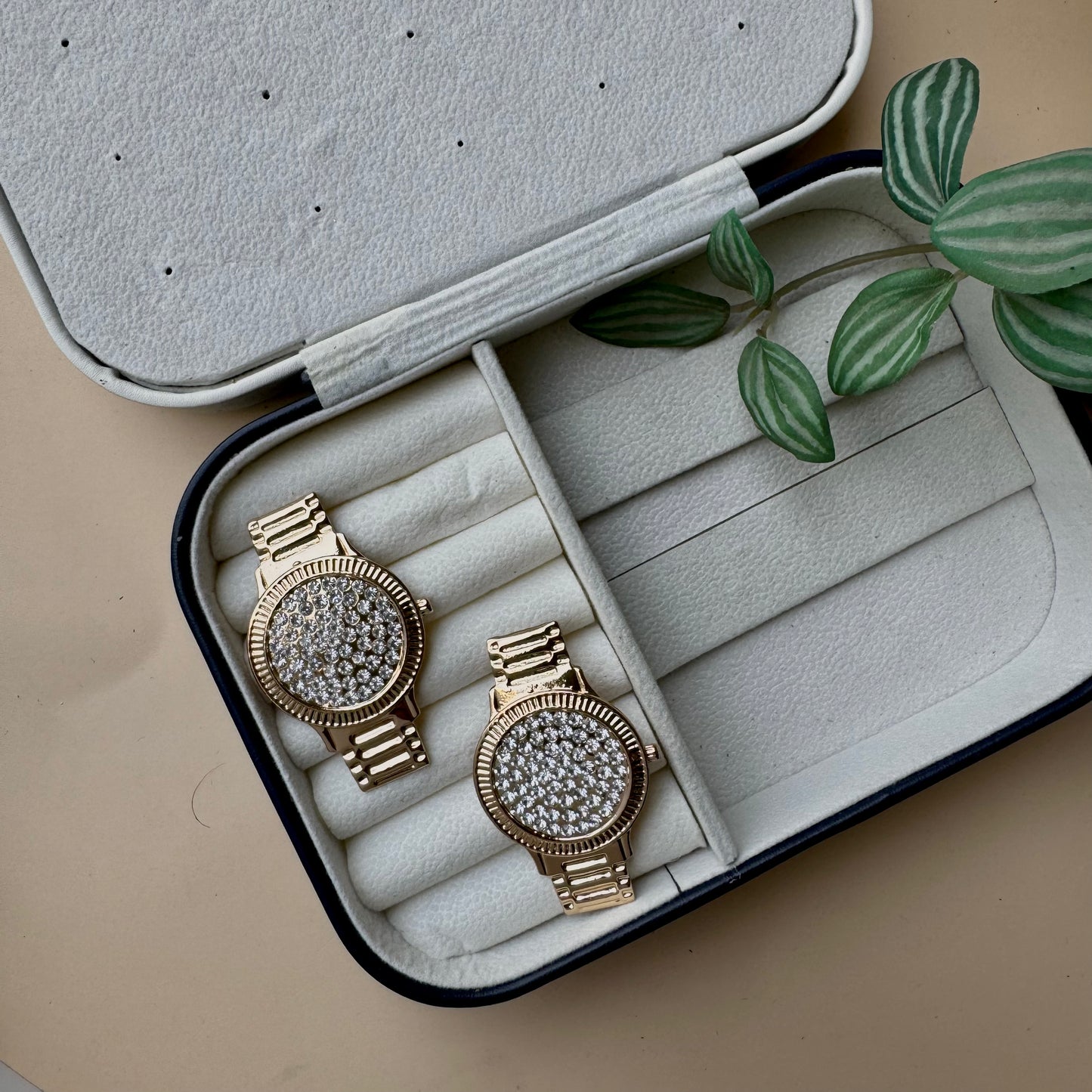 Stylish Lush24 drop earrings with a distinctive studded wristwatch face design, likely available in Mumbai, Maharashtra, India. These gold-toned earrings feature a sparkling, textured surface and a linked drop, presented in a protective jewelry case.
