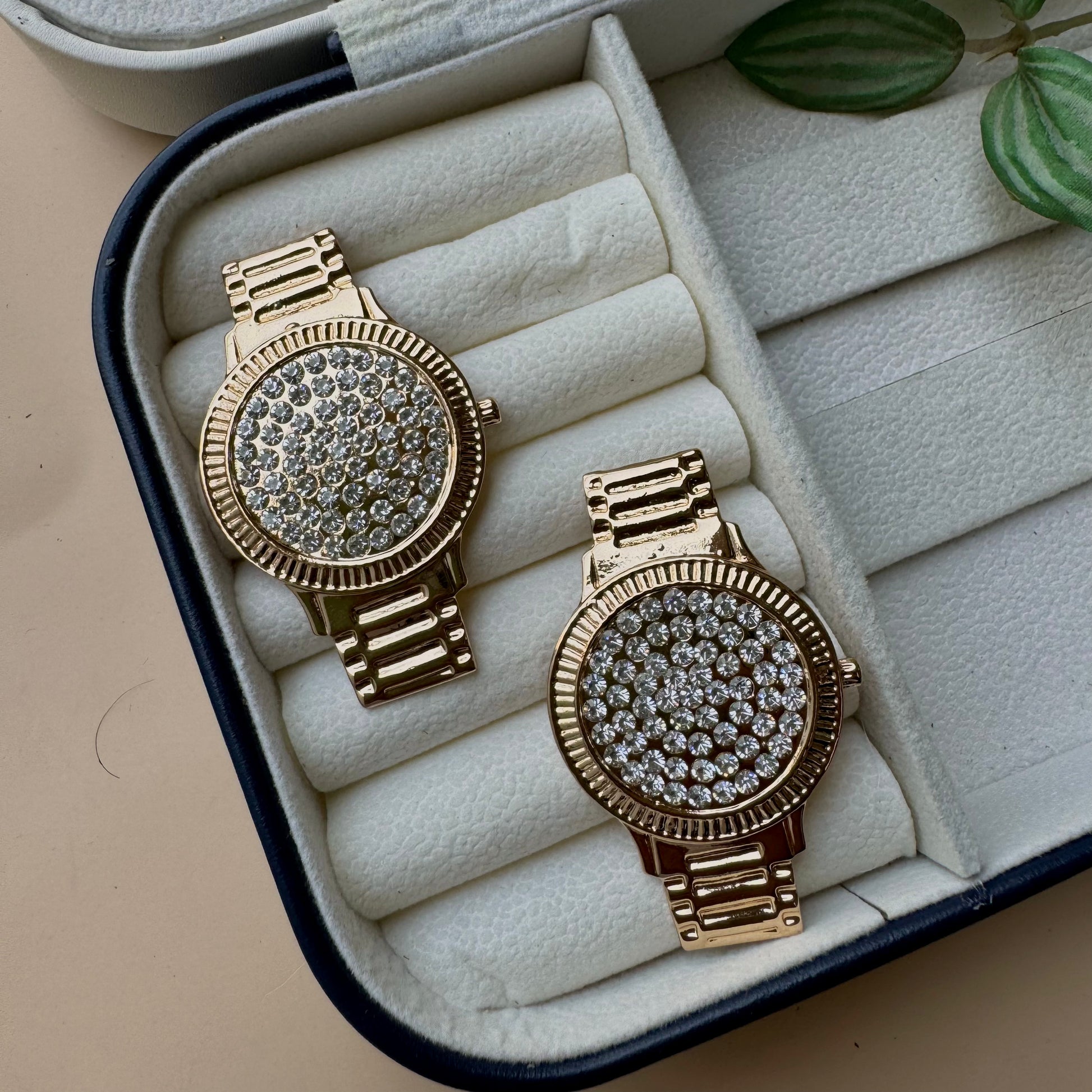 Stylish Lush24 drop earrings with a distinctive studded wristwatch face design, likely available in Mumbai, Maharashtra, India. These gold-toned earrings feature a sparkling, textured surface and a linked drop, presented in a protective jewelry case.