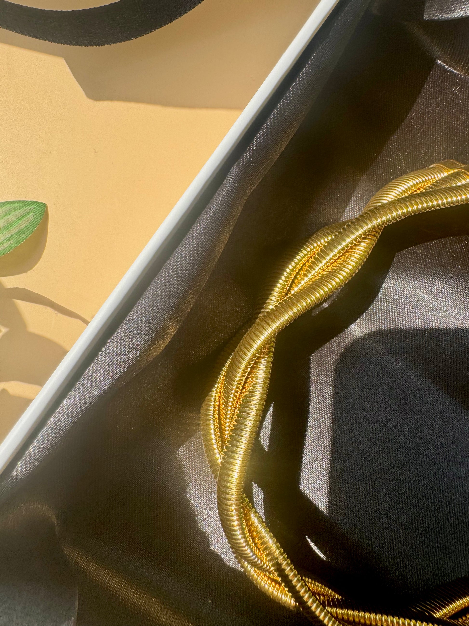 Elegant and locally sourced (Mumbai, Maharashtra, India) triple braided snale necklace by Lush 24. The necklace features a multi-strand design with irregular, luminous design and is packaged in a sophisticated gift box with the brand's logo