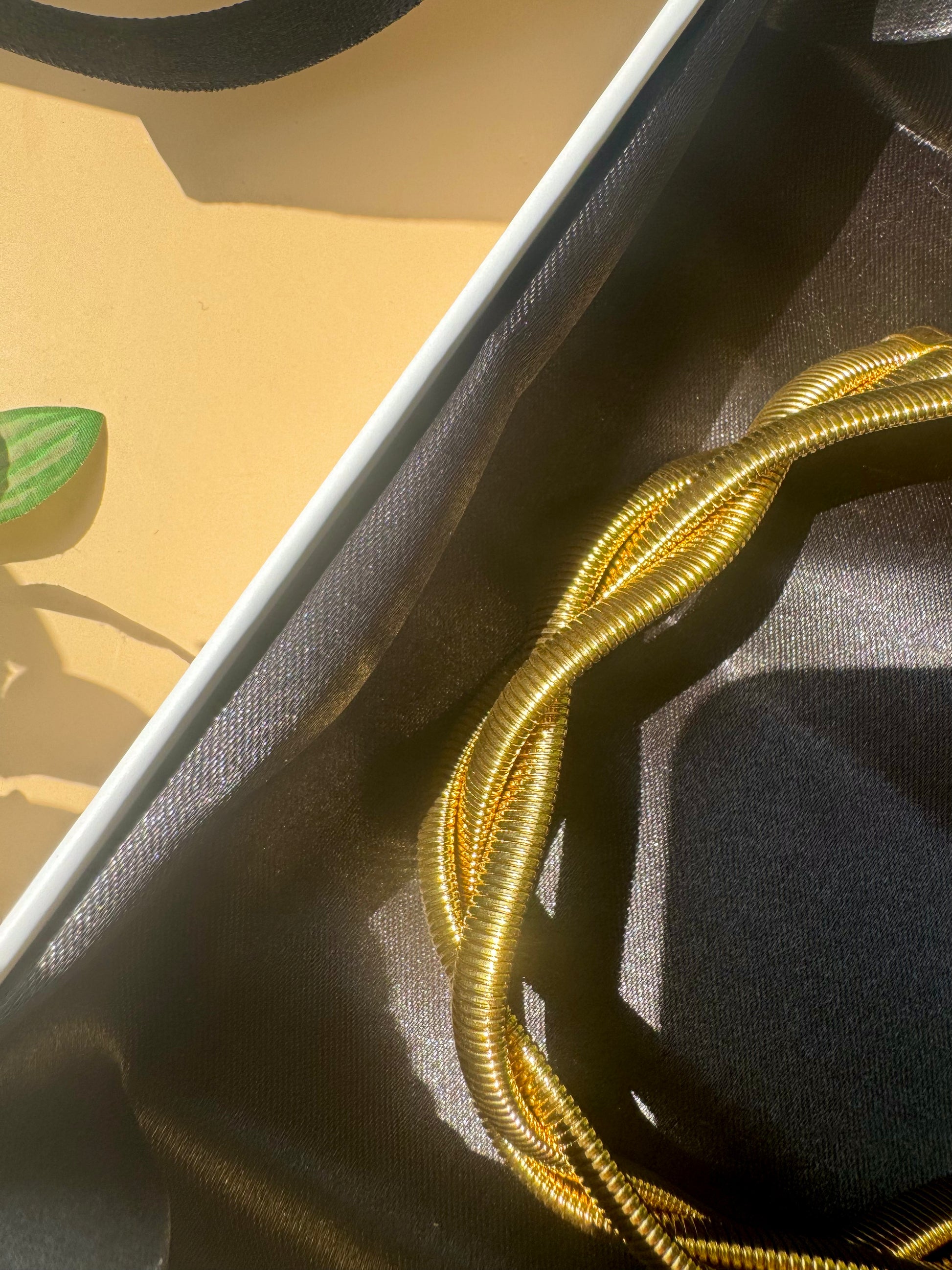 Elegant and locally sourced (Mumbai, Maharashtra, India) triple braided snale necklace by Lush 24. The necklace features a multi-strand design with irregular, luminous design and is packaged in a sophisticated gift box with the brand's logo