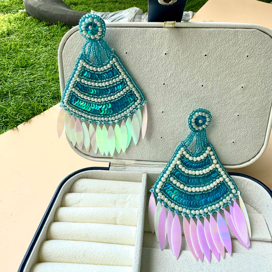 Statement teal sequin and pearl earrings with iridescent feathered drops, exuding a bold and bohemian charm