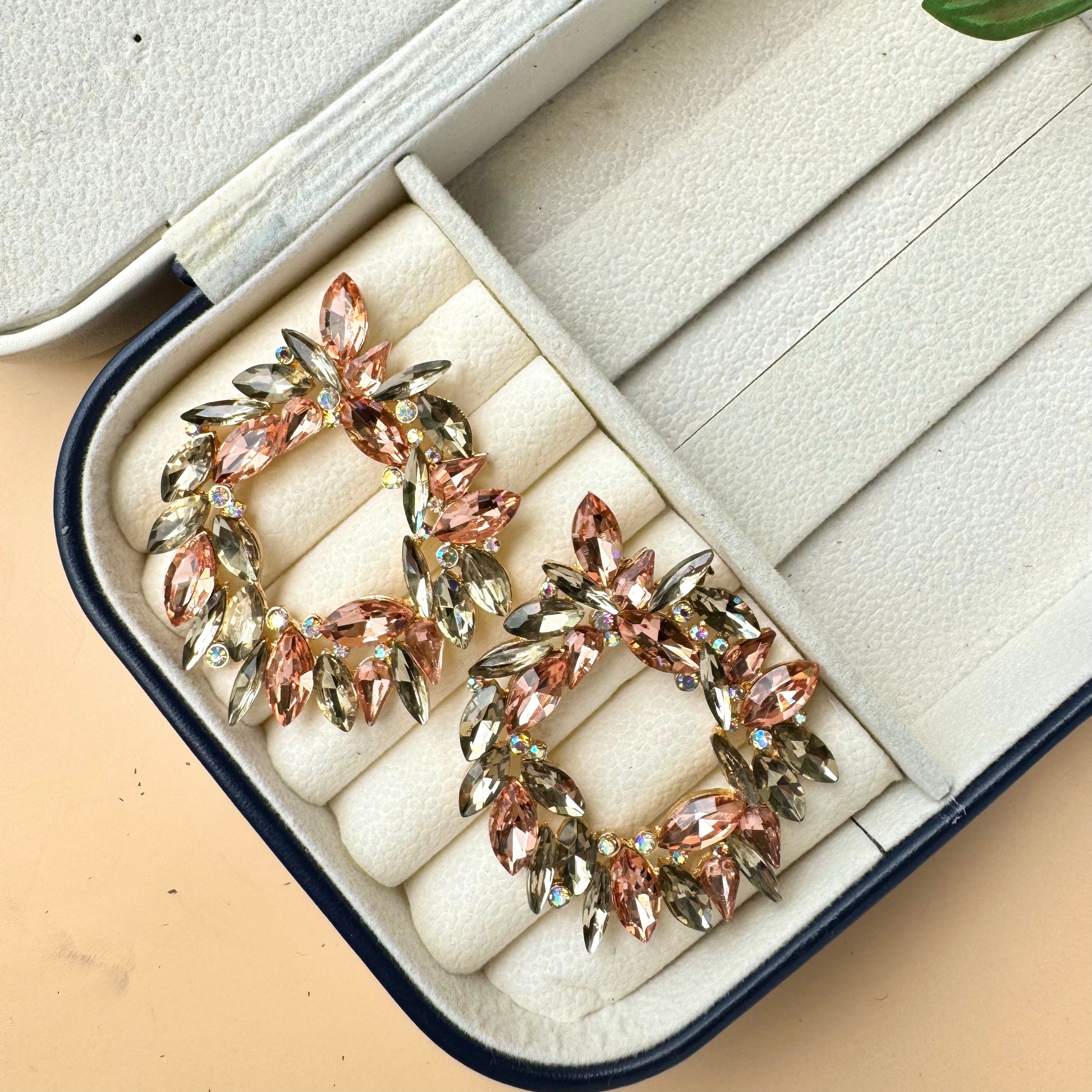 A pair of sophisticated 18K vintage sherman crystal earrings with a dangling, presented in a stylish jewelry case. These earrings are likely available in Mumbai, Maharashtra, India