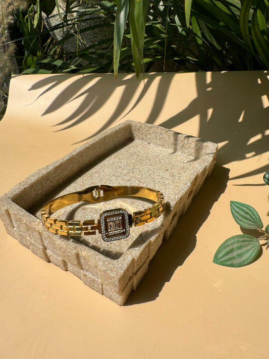Luxury bracelet on a textured surface.