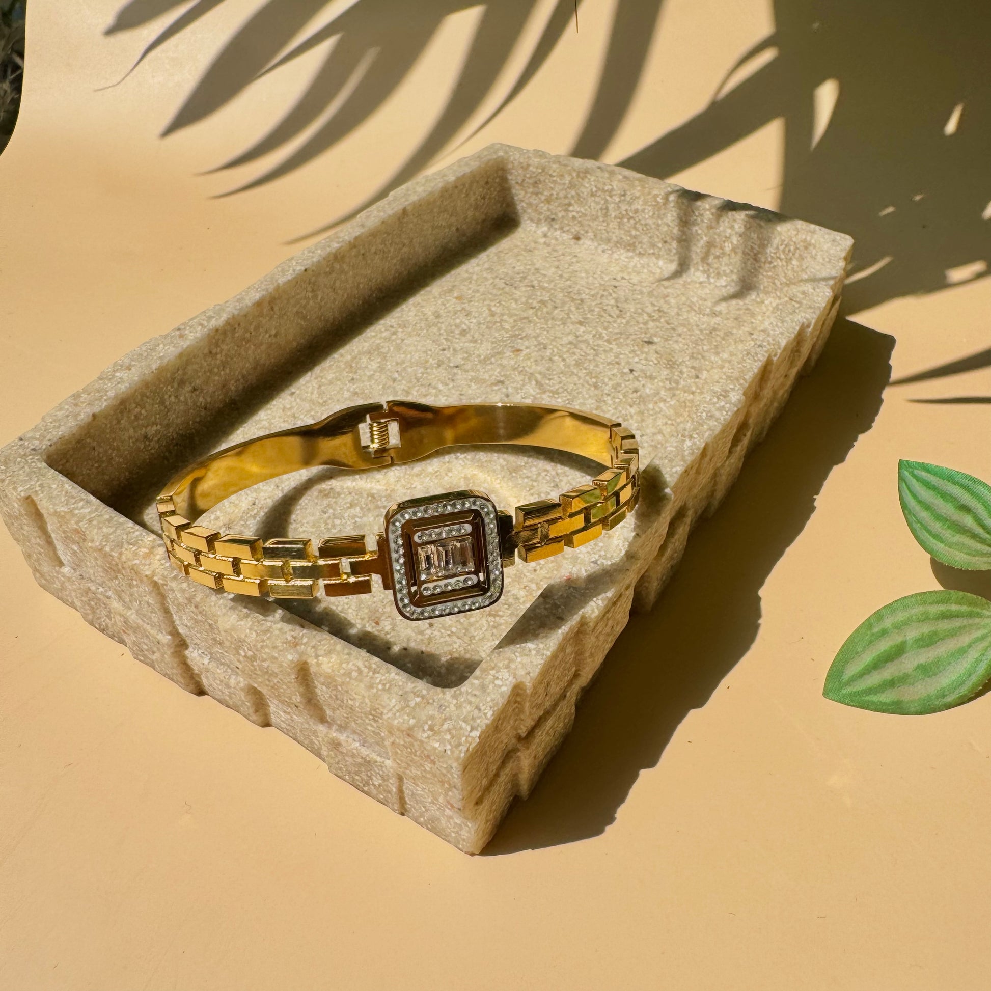 Luxury bracelet on a textured surface.